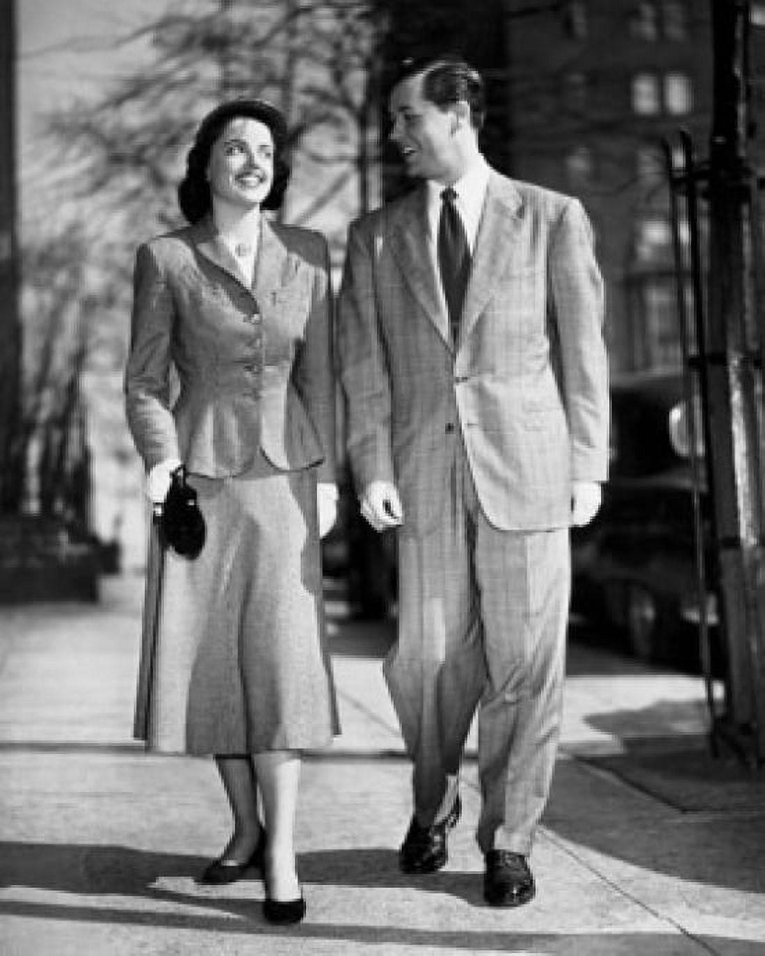 Young couple walking on sidewalk Canvas Art - (24 x 36)