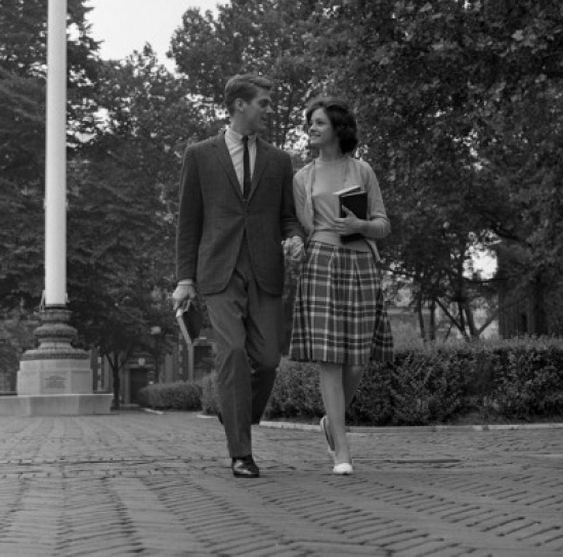 Young couple walking on sidewalk Canvas Art - (24 x 36)