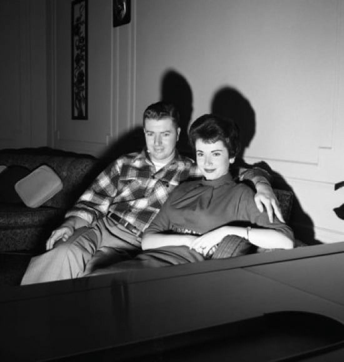 Young couple watching television Canvas Art - (24 x 36)