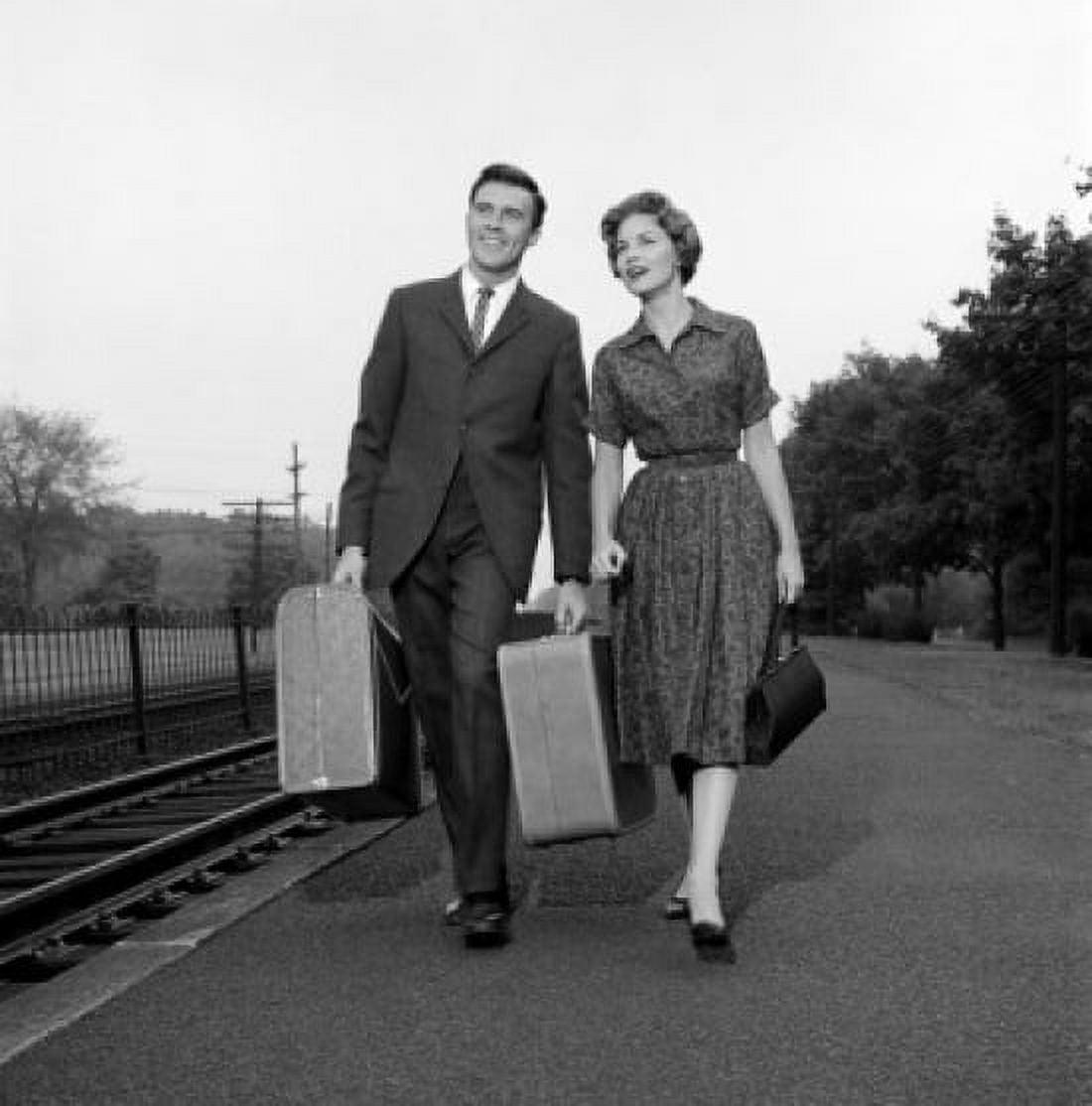 Young couple with suitcase walking at train station Canvas Art - (18 x 24)