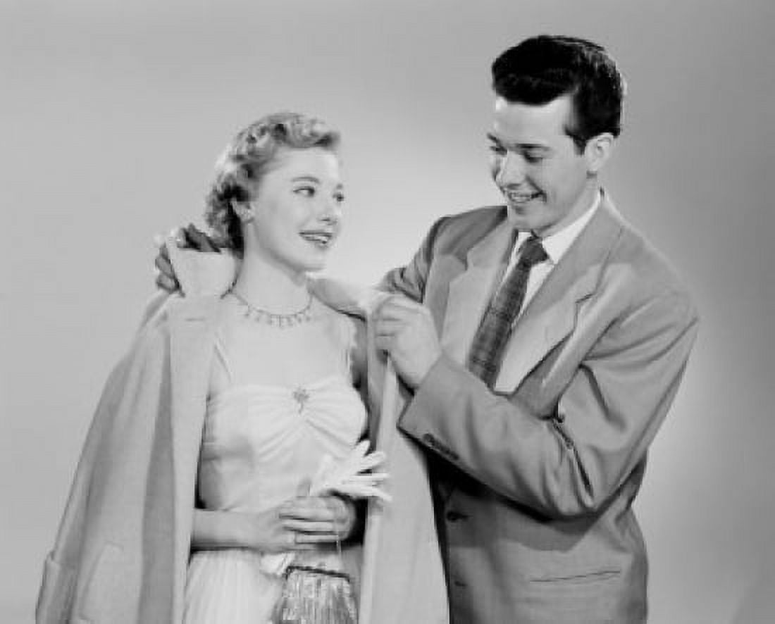 Young gentleman helping lady with overcoat dressing up Canvas Art - (24 x 36)