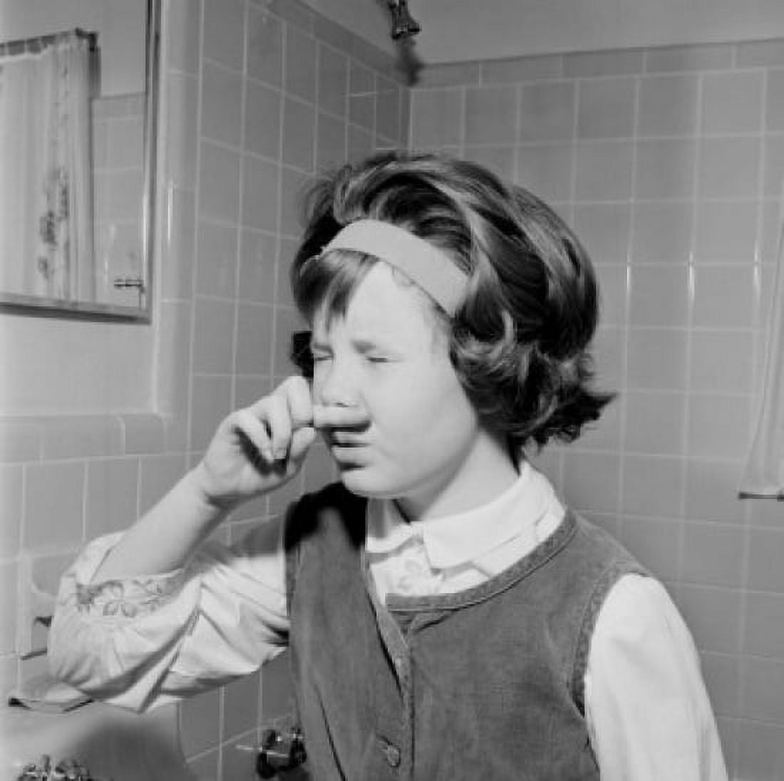 Young girl grimacing in front of bathroom mirror Canvas Art - (24 x 36)