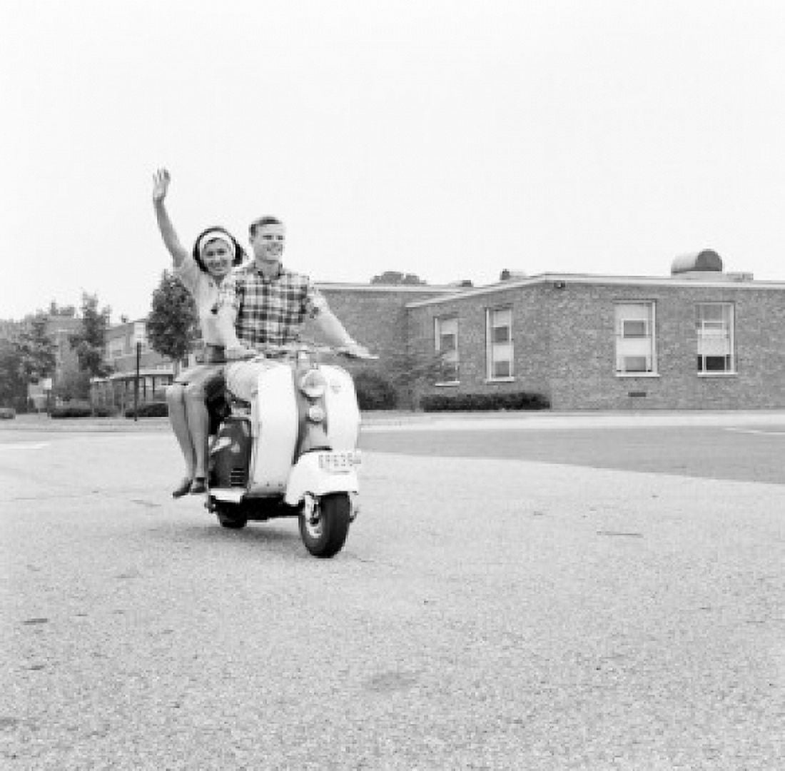 Young happy couple driving scooter Canvas Art - (18 x 24)