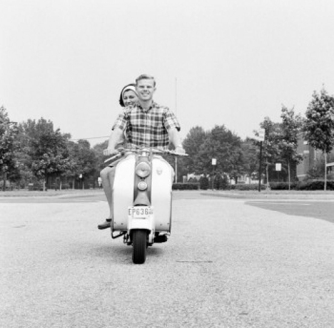 Young happy couple driving scooter Canvas Art - (24 x 36)