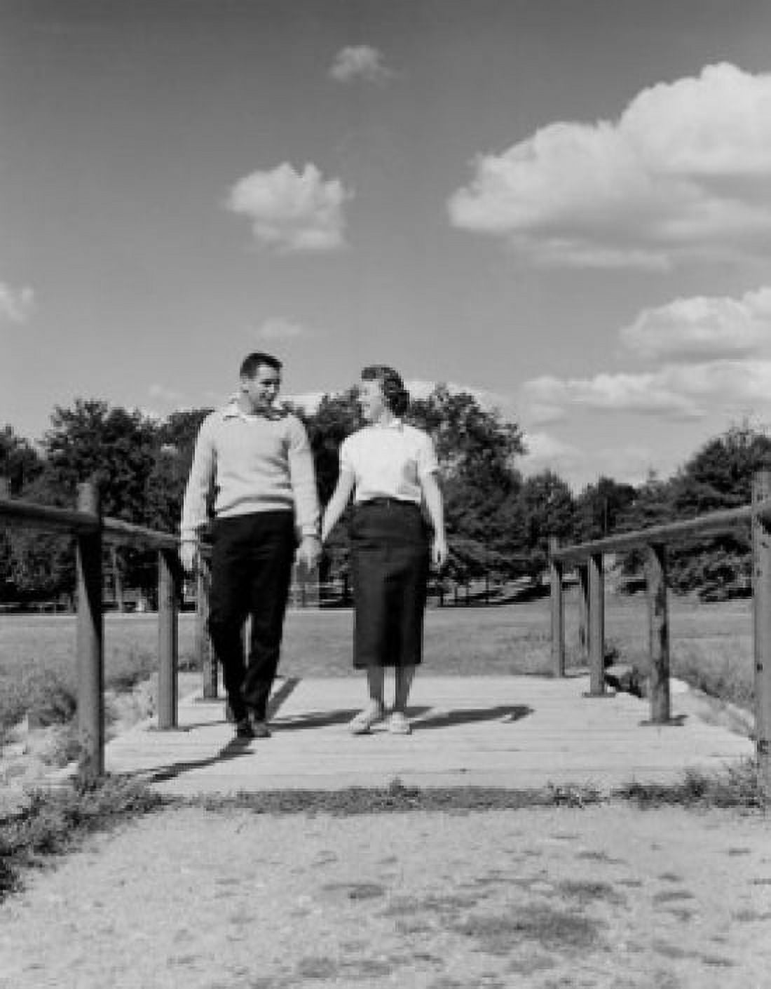 Young happy couple walking and holding hands Canvas Art - (24 x 36)