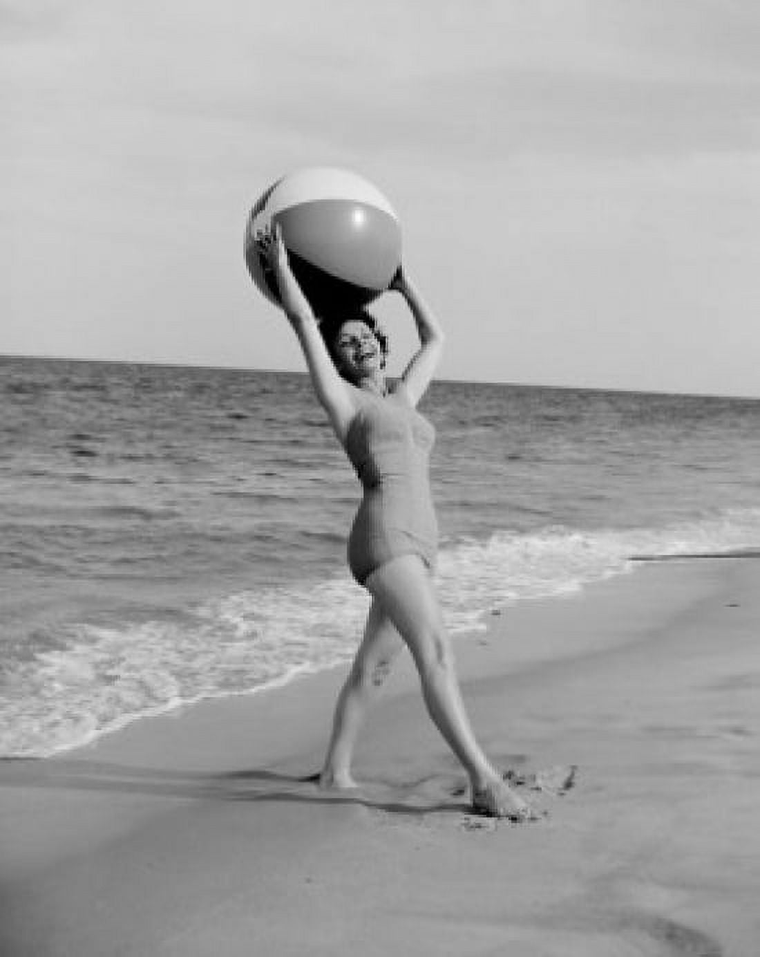 Young happy woman holding beach ball and looking at camera at beach Canvas Art - (24 x 36)