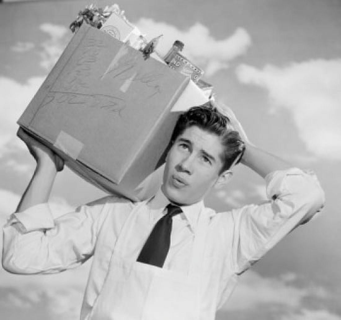 Young man carrying grocery box outdoors Canvas Art - (24 x 36)