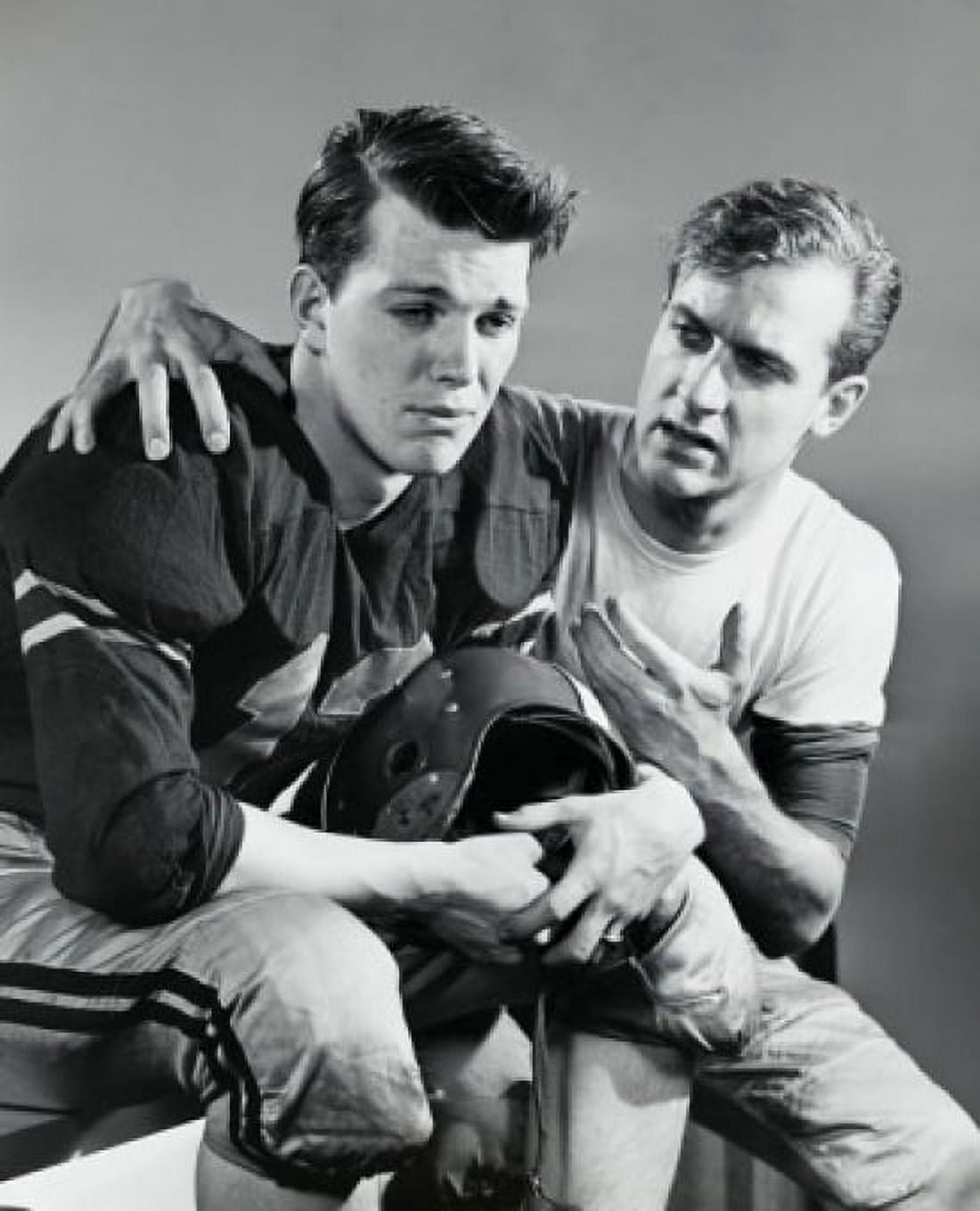 Young man consoling a football player Canvas Art - (18 x 24)