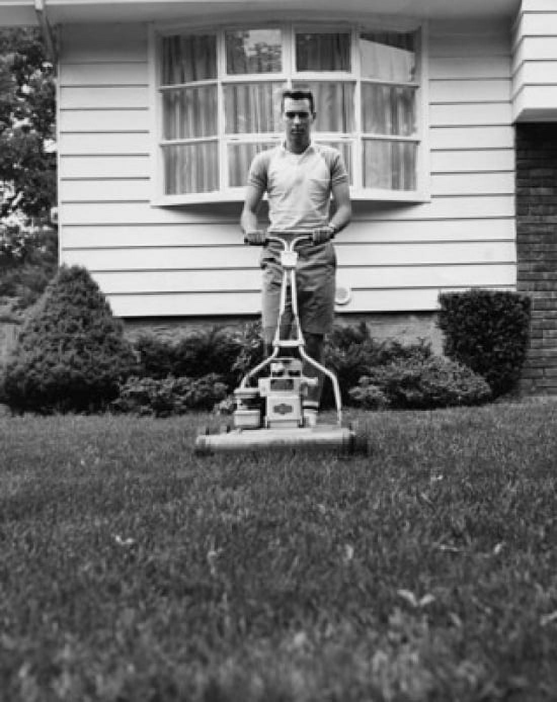 Young man cutting grass with a lawn mower Canvas Art - (24 x 36)
