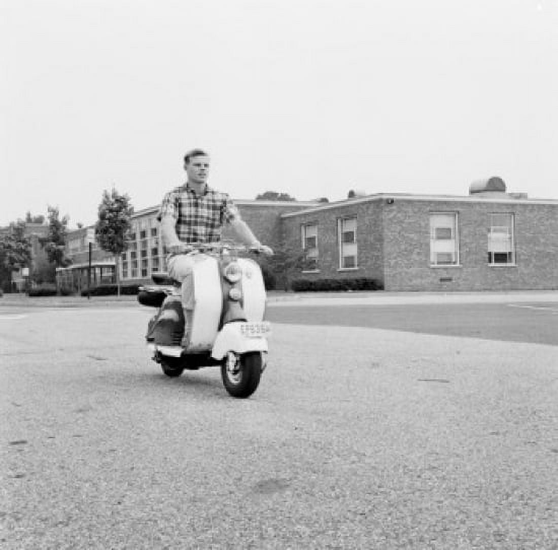 Young man driving scooter Canvas Art - (18 x 24)