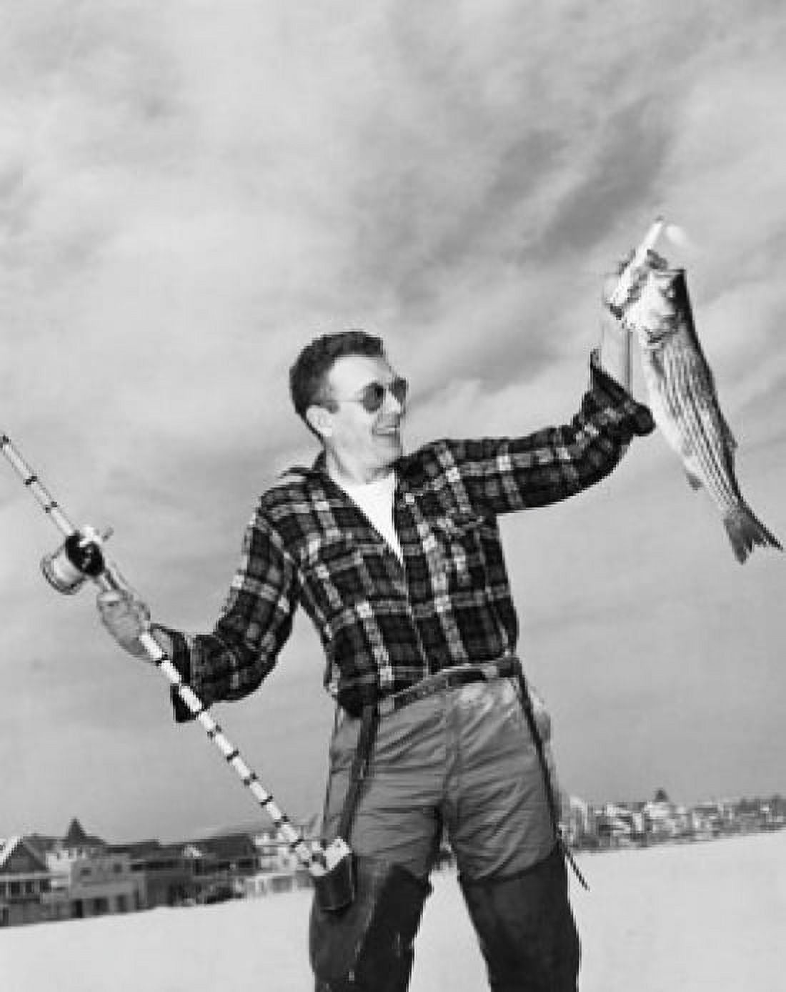 Young man holding fish and fishing rod Canvas Art - (24 x 36)