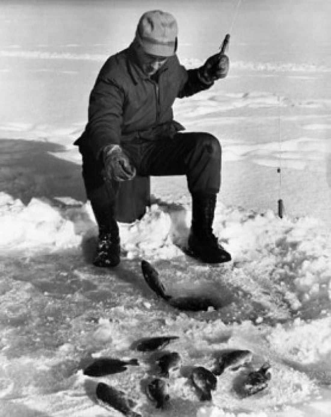 Young man ice fishing on a frozen lake Canvas Art - (18 x 24)