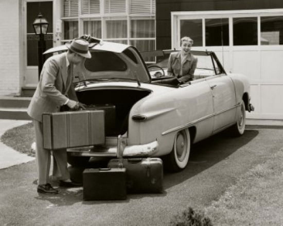 Young man loading luggage into the trunk of a car Canvas Art - (24 x 36)