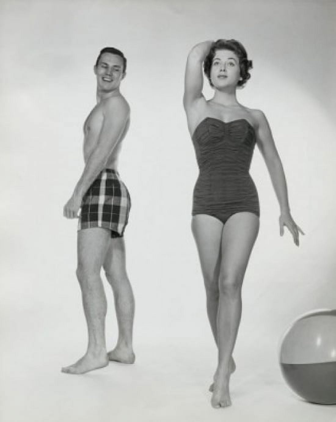 Young man looking at a young woman walking in swimsuit Canvas Art - (18 x 24)