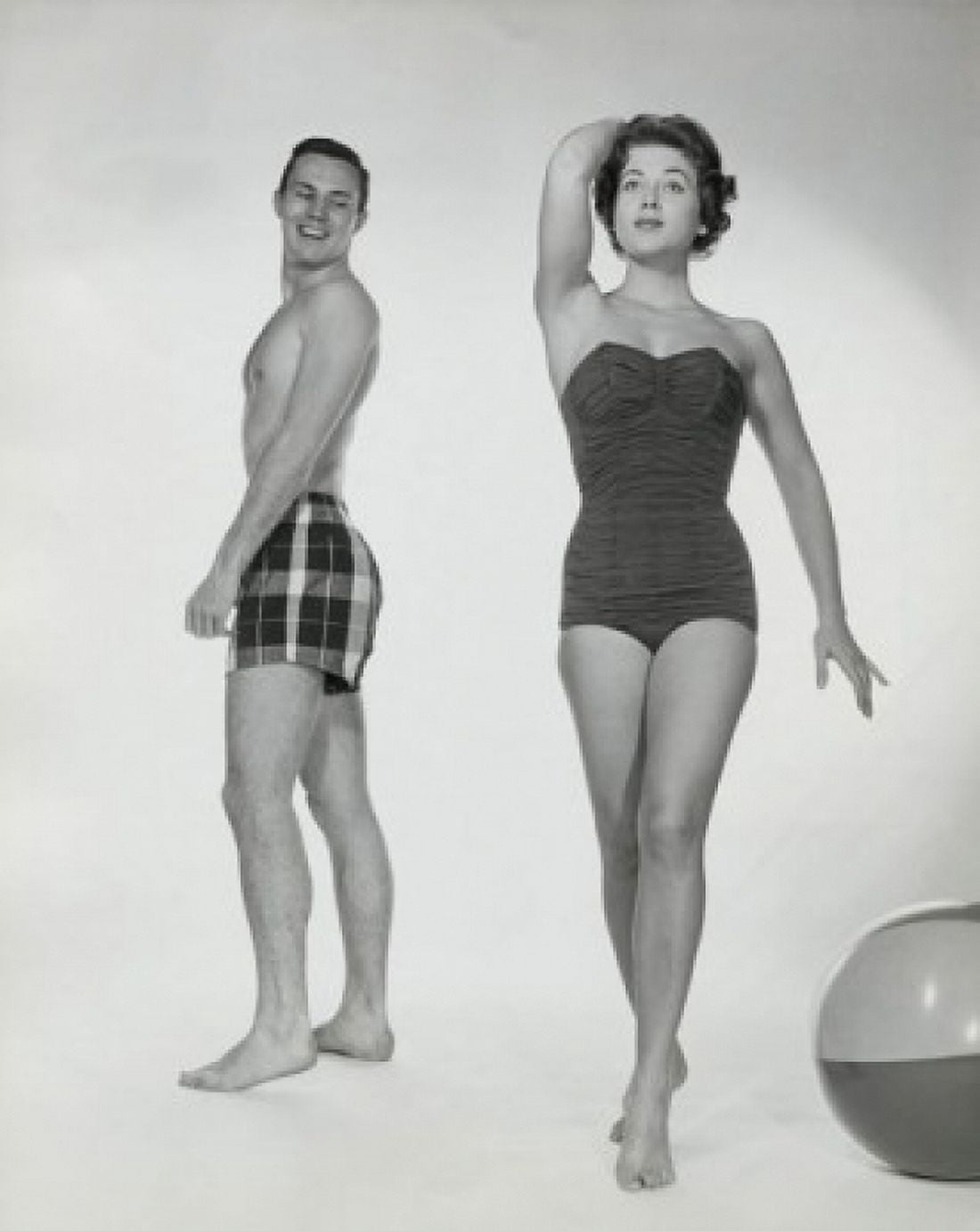 Young man looking at a young woman walking in swimsuit Canvas Art - (24 x 36)