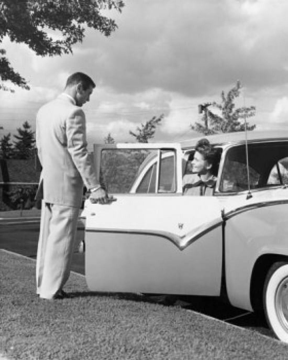 Young man opening the door of a car for a teenage girl Canvas Art - (18 x 24)