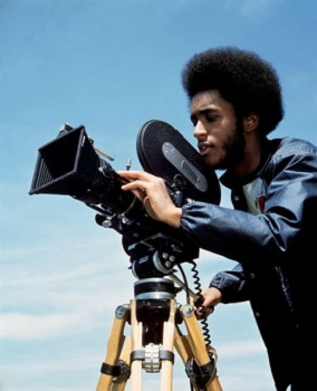Young man operating a movie camera Canvas Art - (24 x 36)