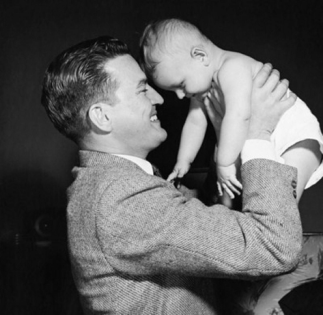 Young man picking up his baby and smiling Canvas Art - (24 x 36)