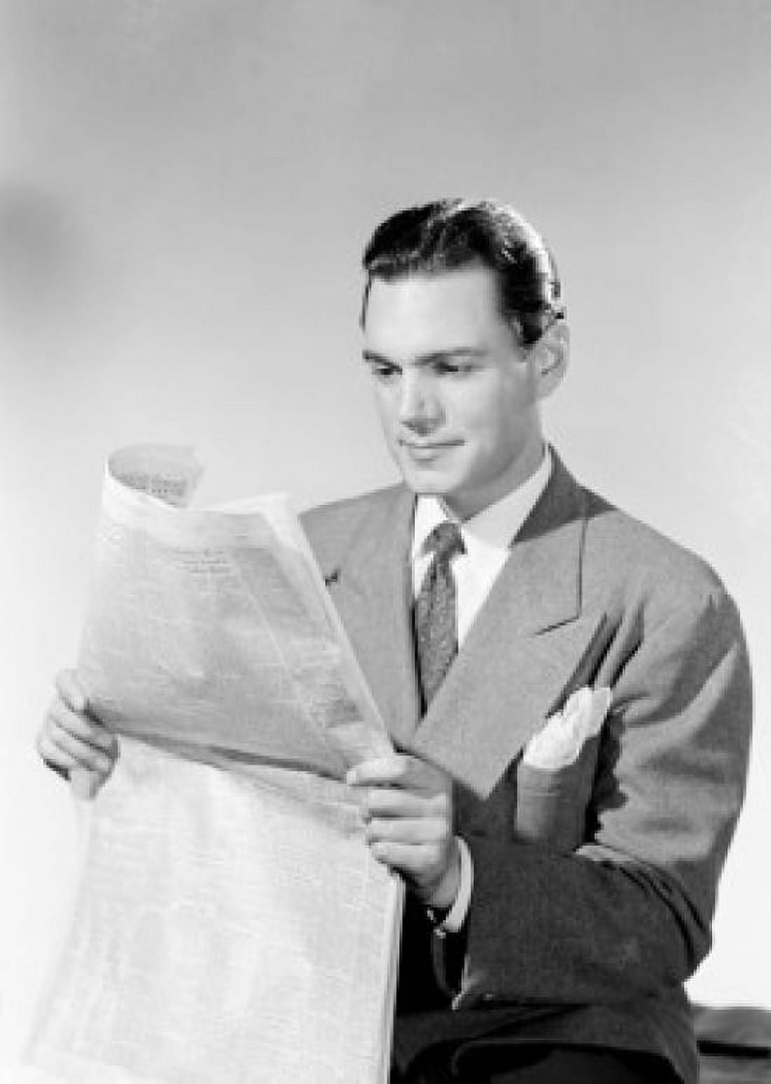 Young man reading newspaper Canvas Art - (18 x 24)