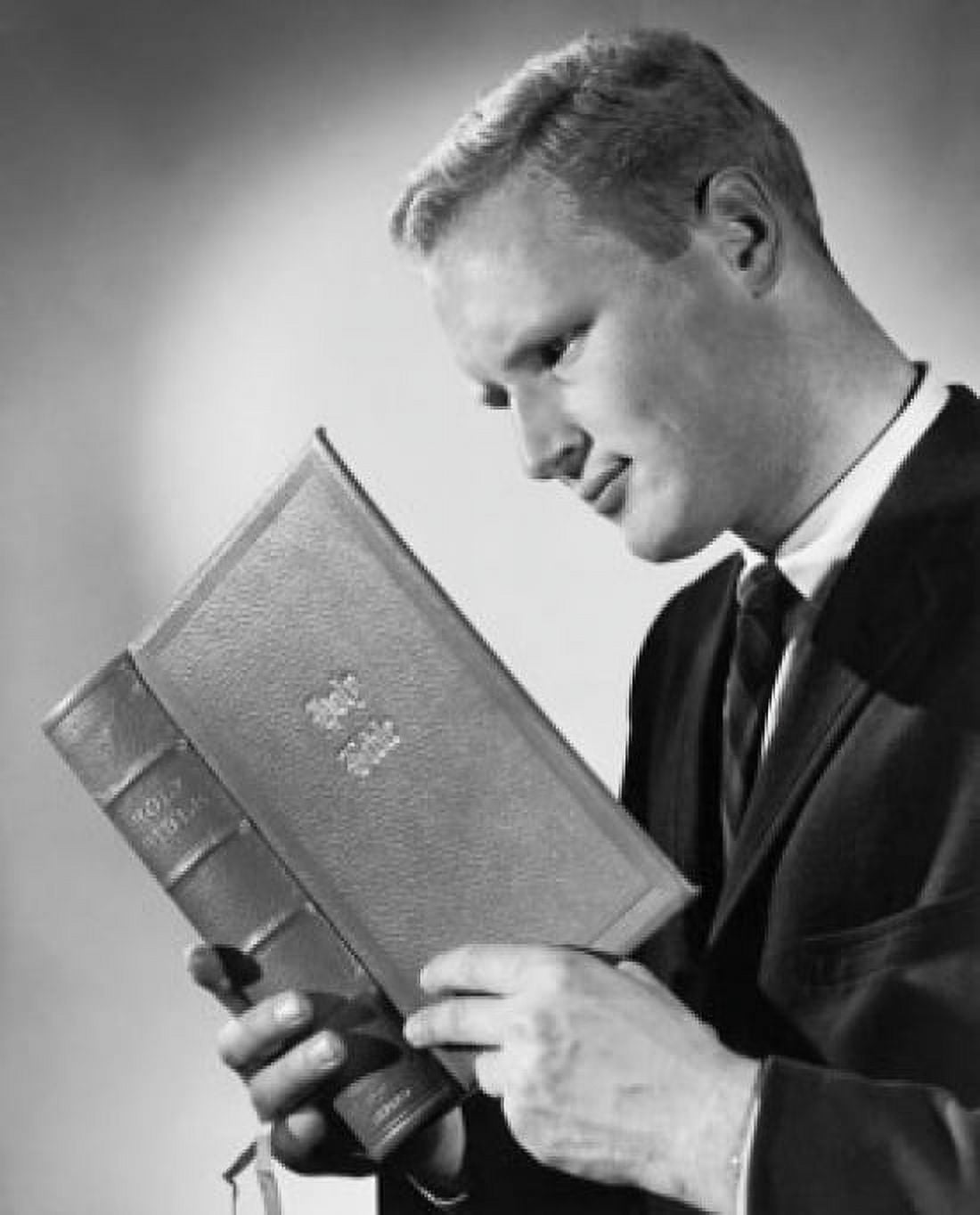 Young man reading the Bible Canvas Art - (18 x 24)