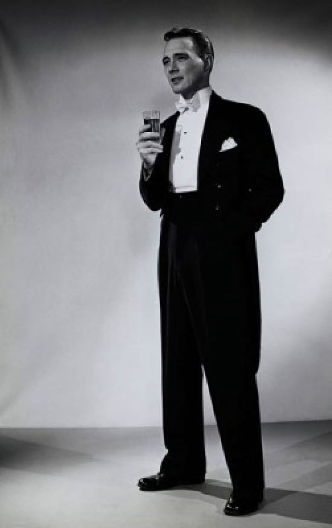 Young man standing and holding a glass Canvas Art - (18 x 24)