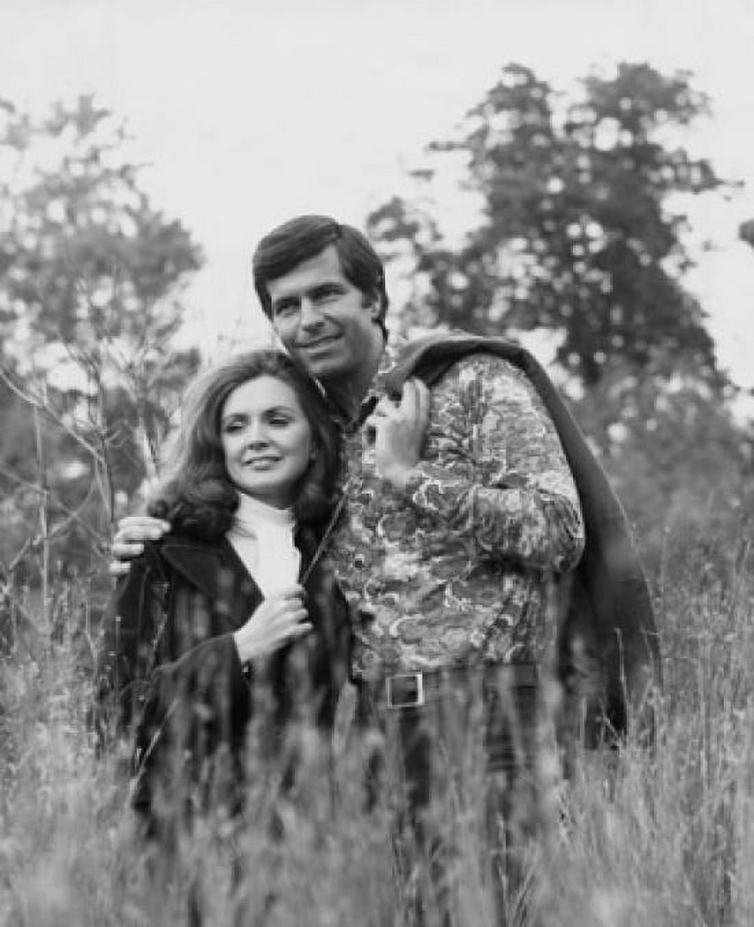 Young man standing with his arm around a young woman in a field Canvas Art - (18 x 24)