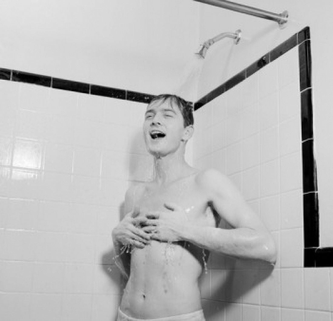 Young man taking shower Canvas Art - (24 x 36)
