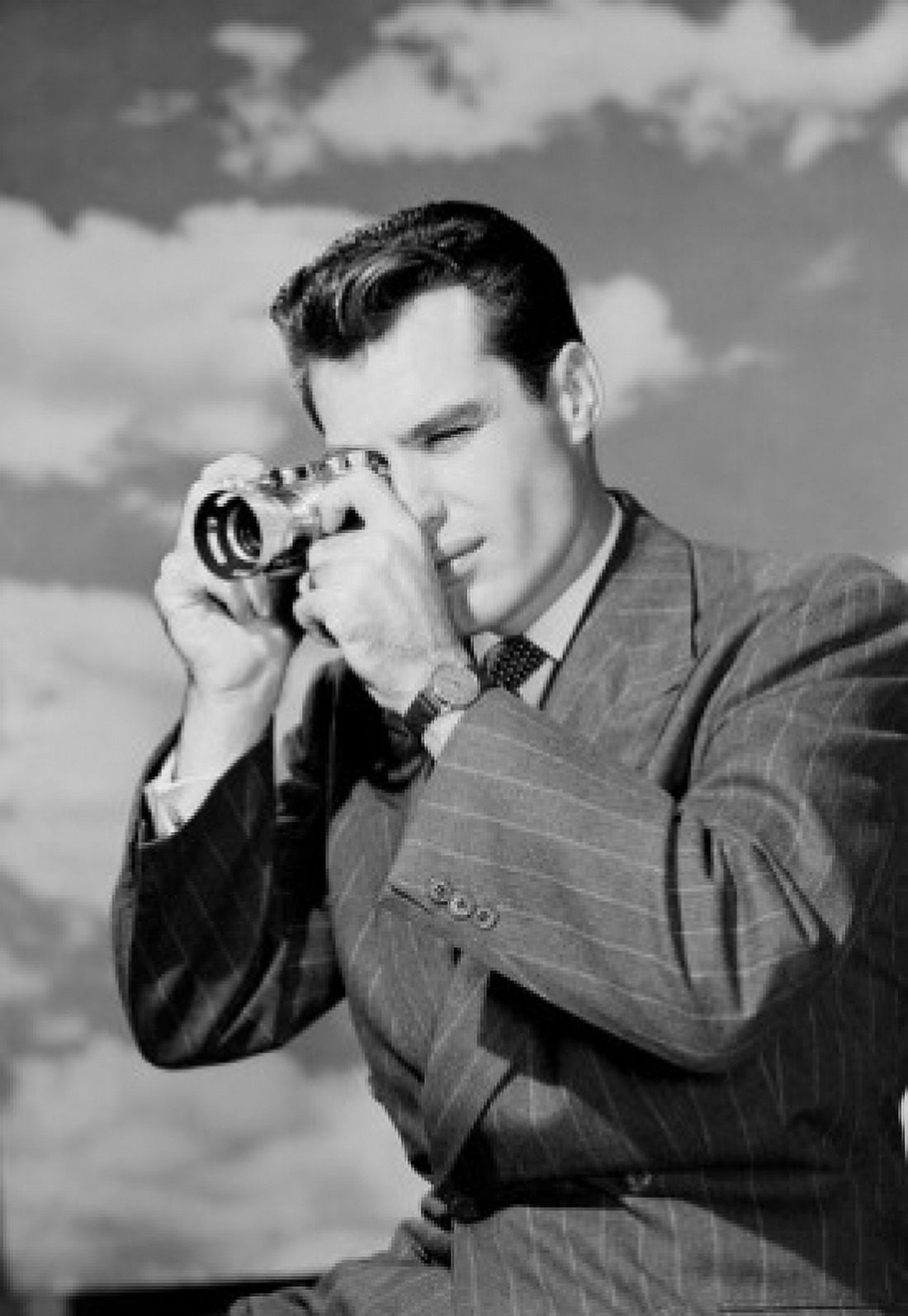 Young man using camera against cloudy sky Canvas Art - (18 x 24)