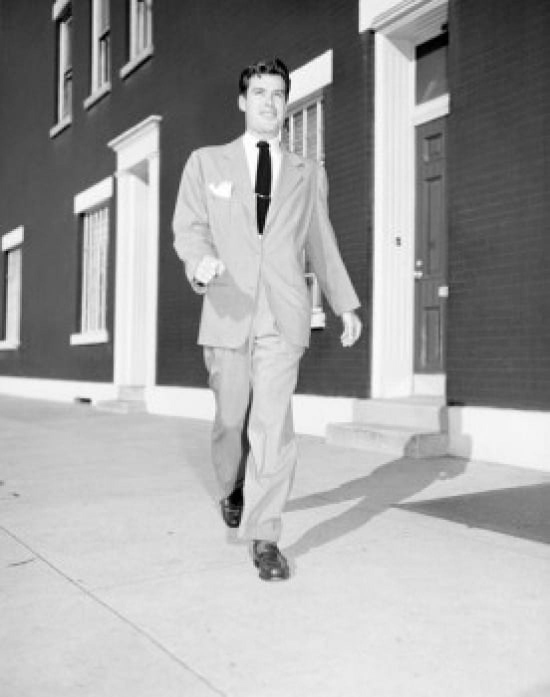 Young man walking on sidewalk Canvas Art - (18 x 24)
