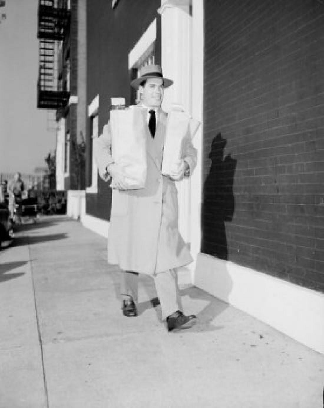 Young man walking on sidewalk carrying shopping bags Canvas Art - (18 x 24)