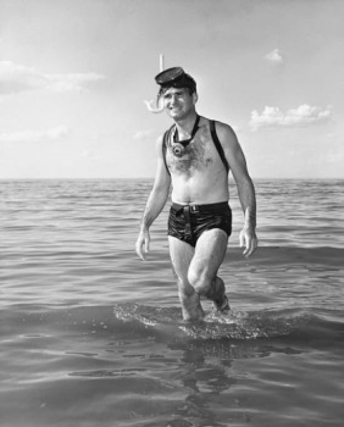 Young man wearing snorkel wading in water Canvas Art - (18 x 24)