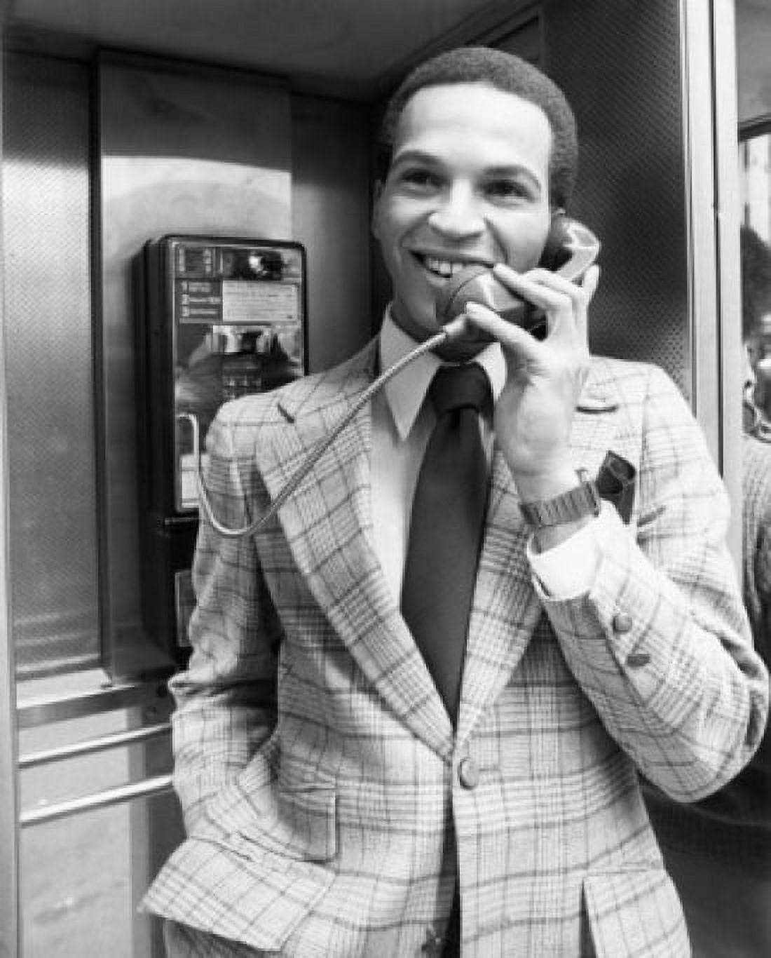 Young man wearing suit talking in telephone booth Canvas Art - (18 x 24)