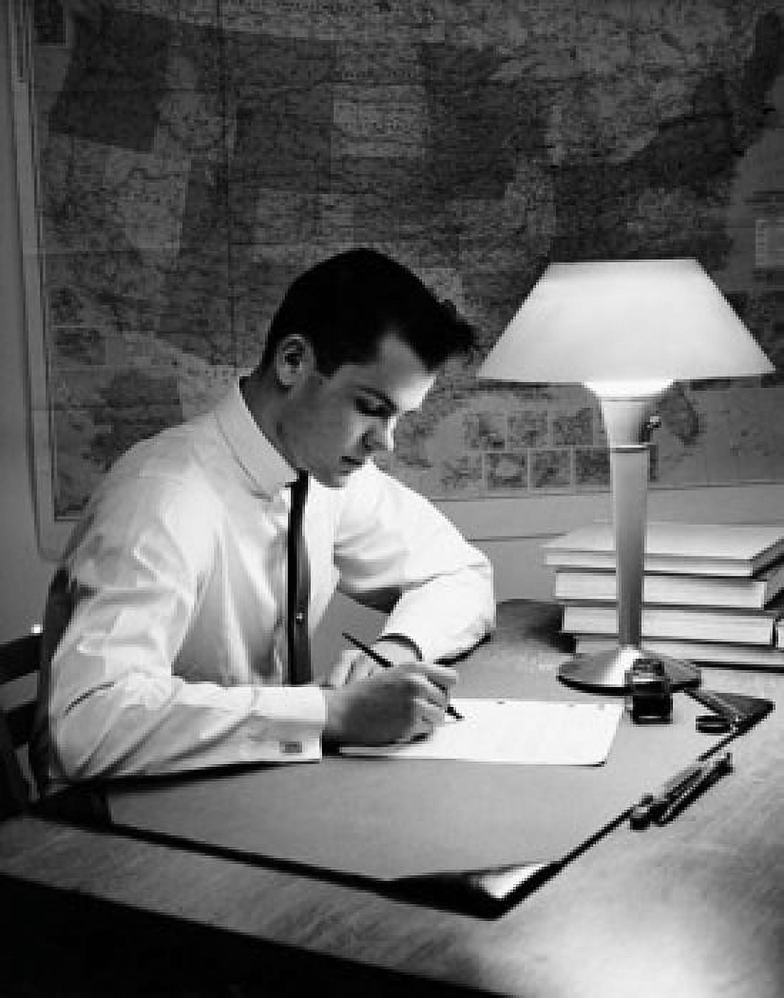 Young man writing on a sheet of paper Canvas Art - (24 x 36)