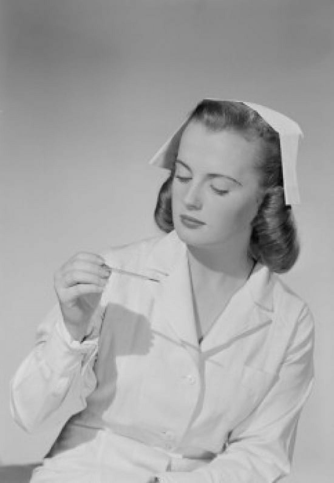 Young nurse looking at thermometer Canvas Art - (18 x 24)