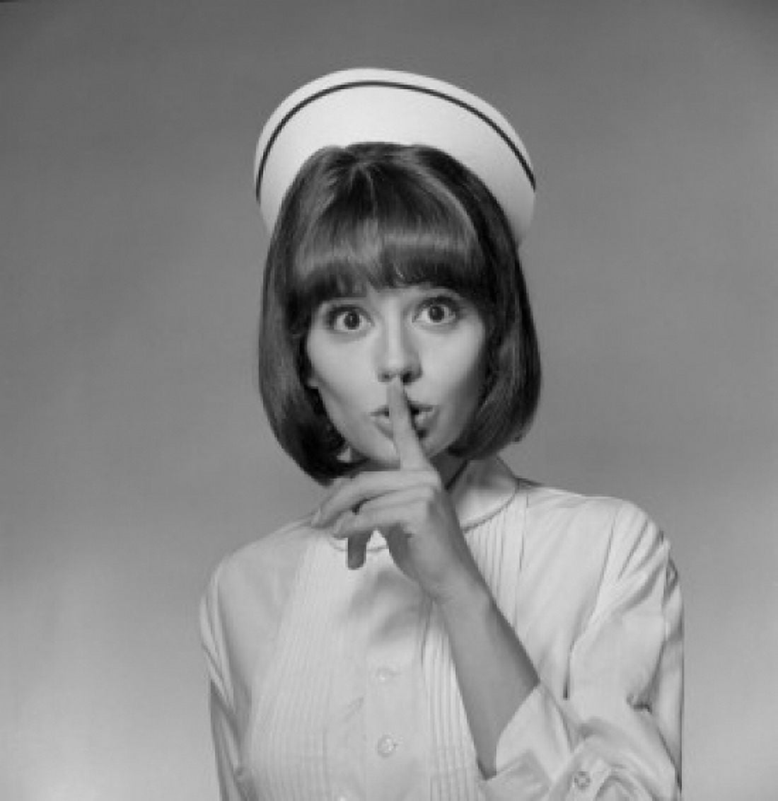 Young nurse with finger on lips Canvas Art - (18 x 24)