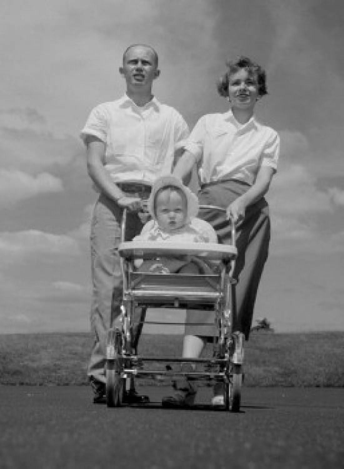 Young parents with child sitting in baby carriage Canvas Art - (24 x 36)