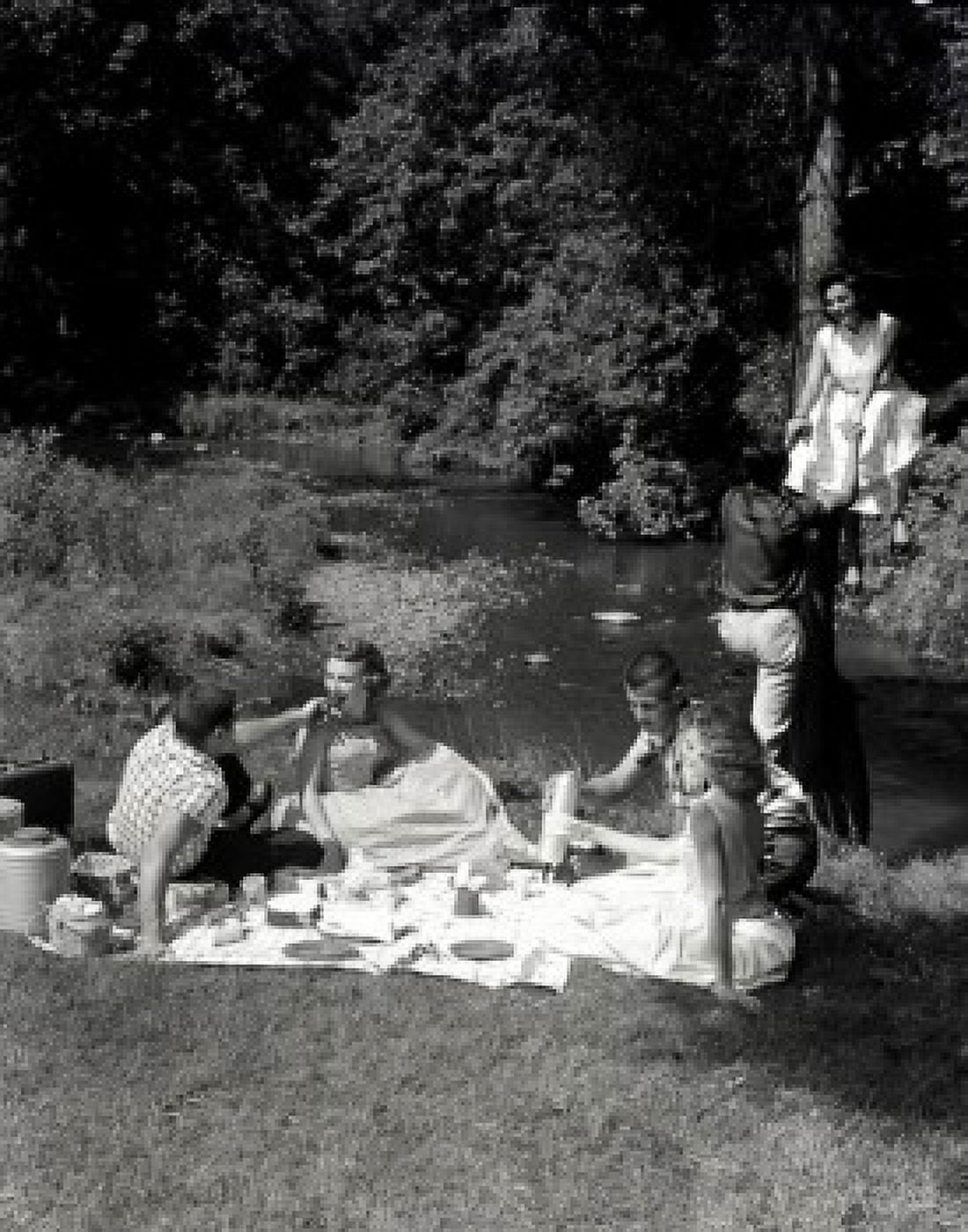 Young people having picnic on river bank Canvas Art - (18 x 24)