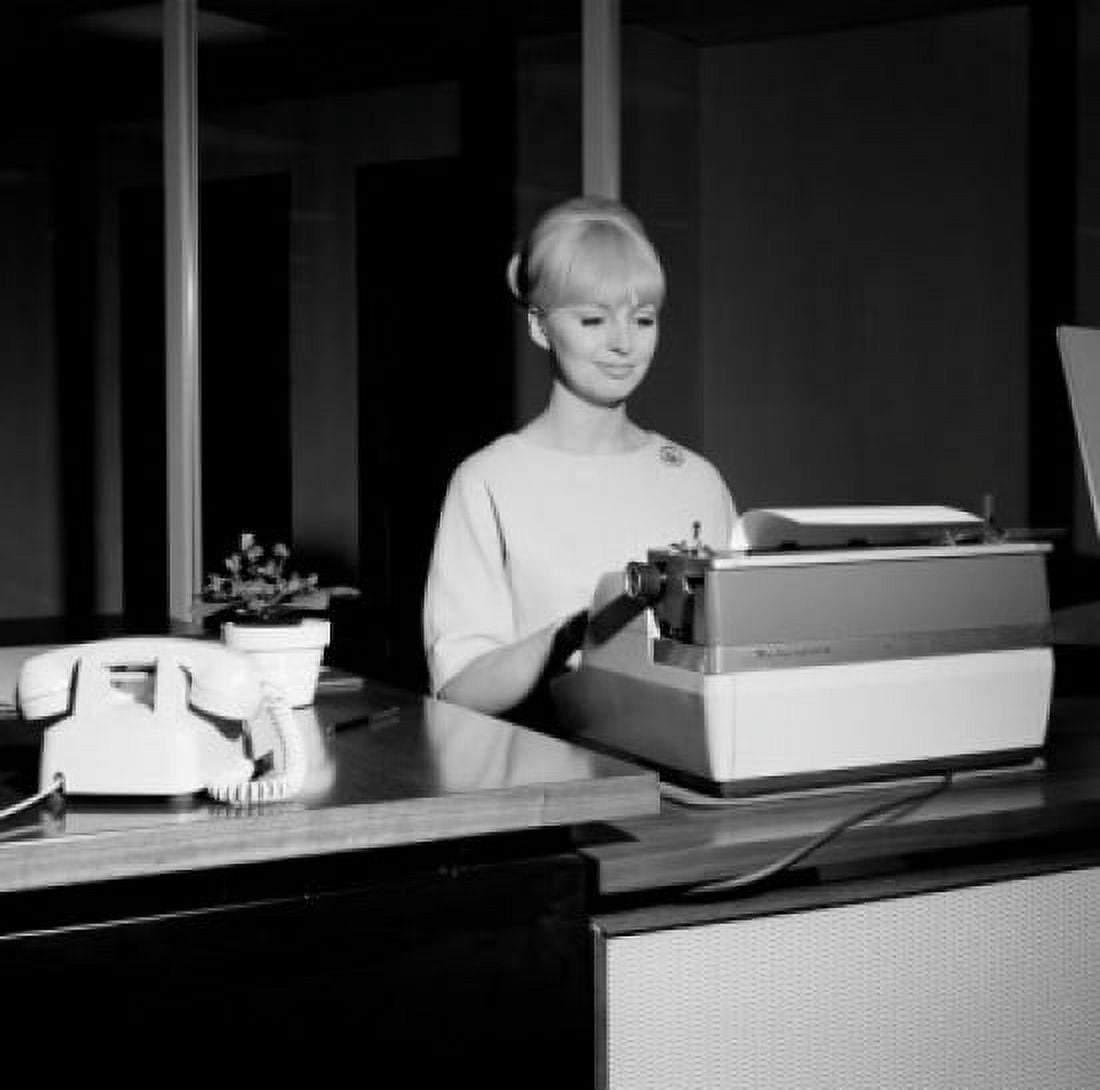 Young secretary working on typing machine Canvas Art - (18 x 24)