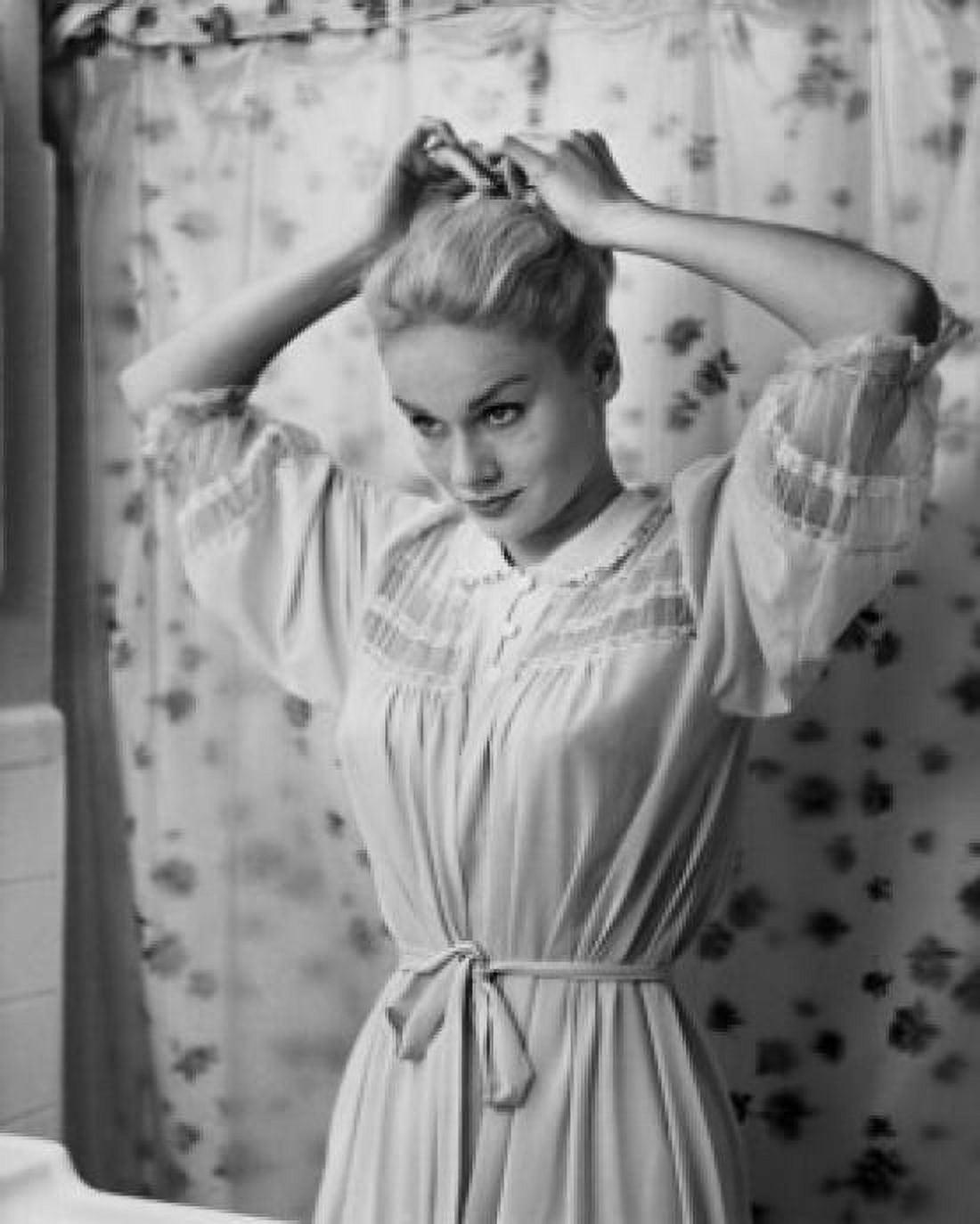 Young woman adjusting her hair in the bathroom Canvas Art - (18 x 24)