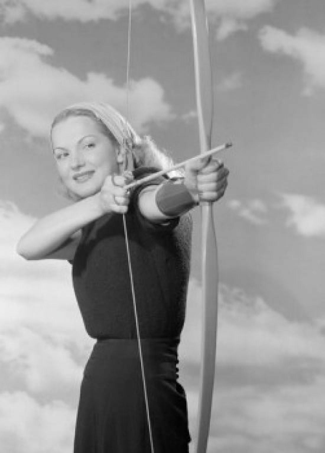 Young woman aiming bow and arrow outdoors Canvas Art - (18 x 24)