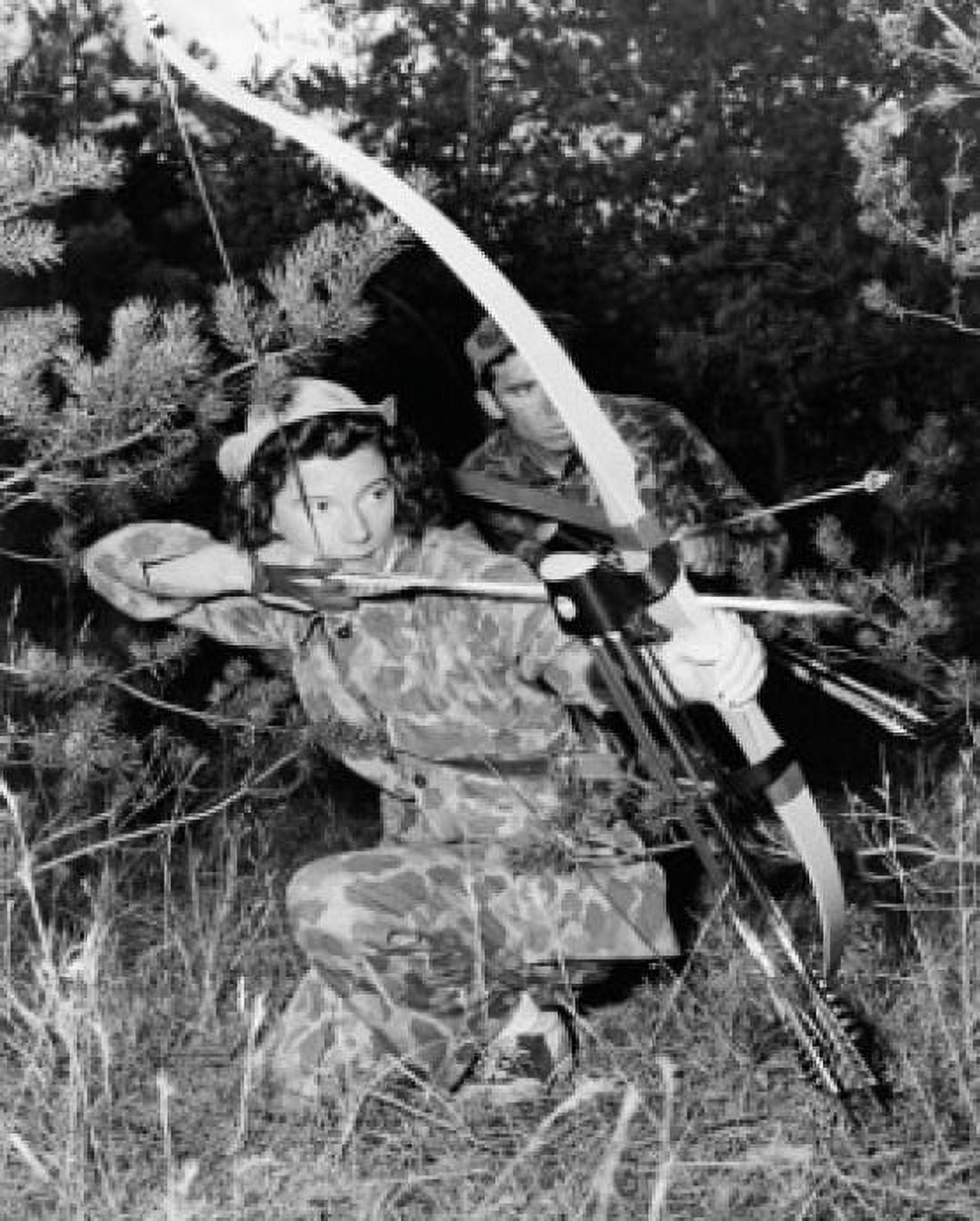 Young woman and a young man hunting with a compound bow in a forest Canvas Art - (18 x 24)