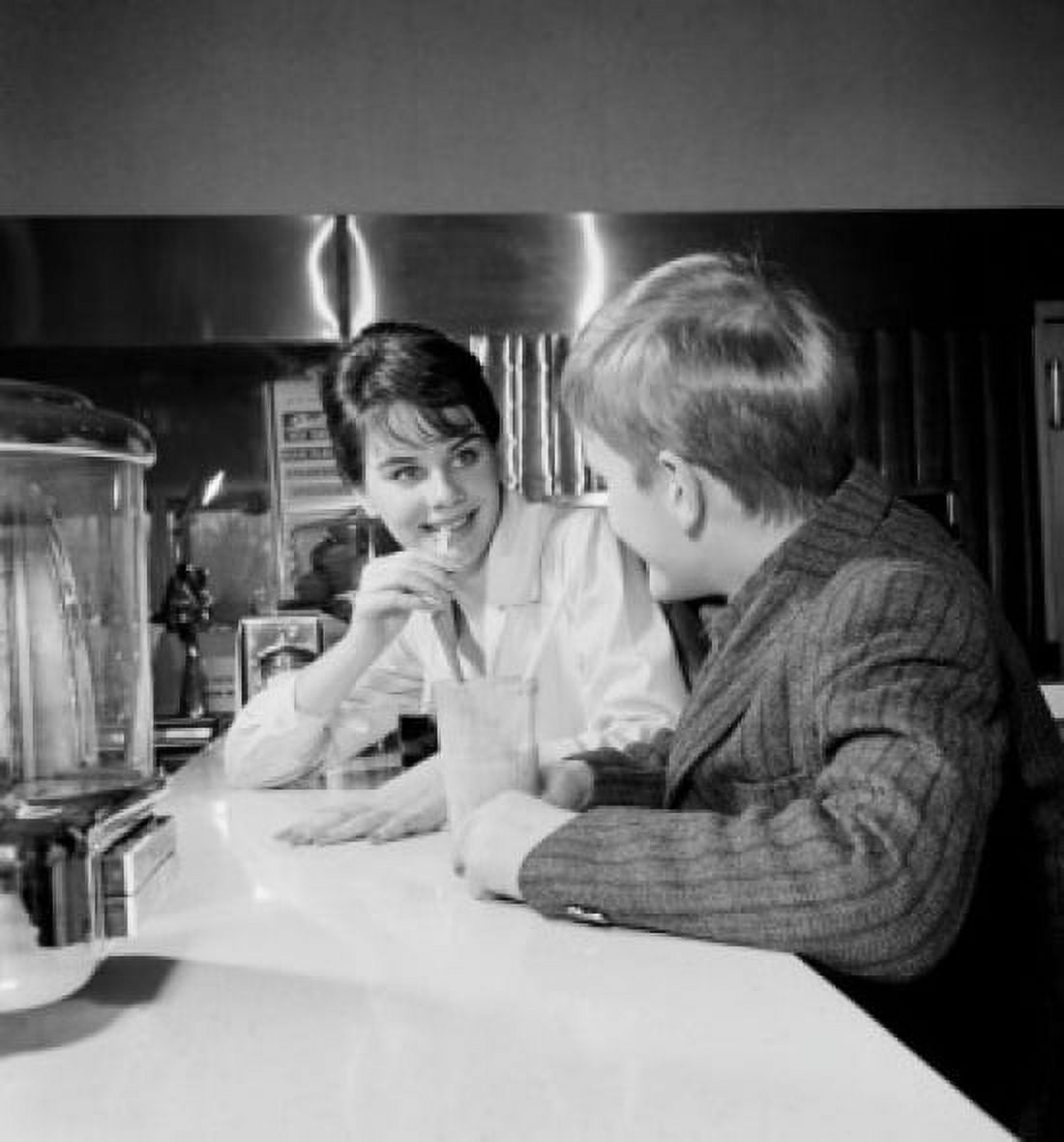 Young woman and boy sitting in restaurant Canvas Art - (24 x 36)