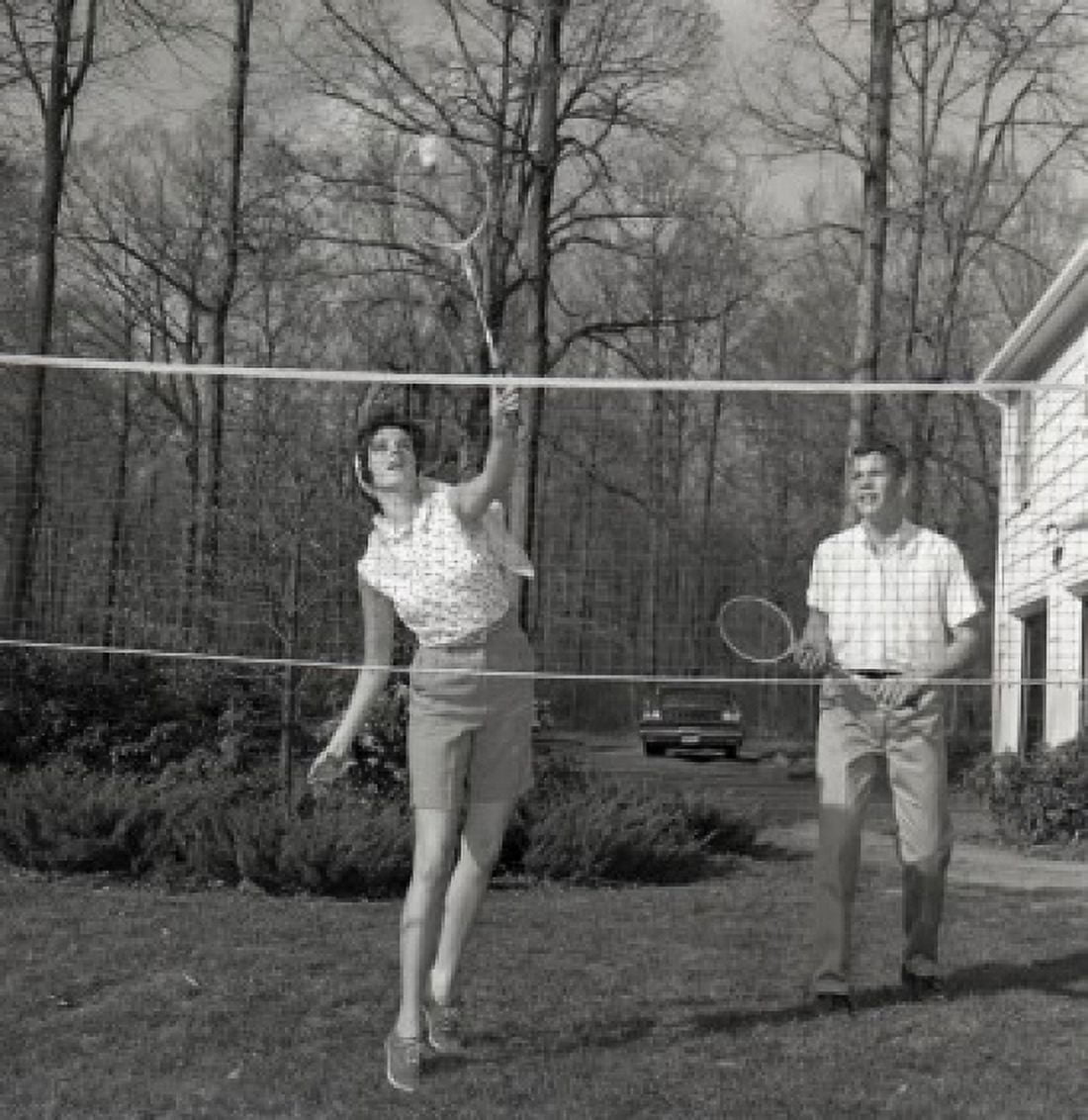 Young woman and young man playing badminton Canvas Art - (24 x 36)