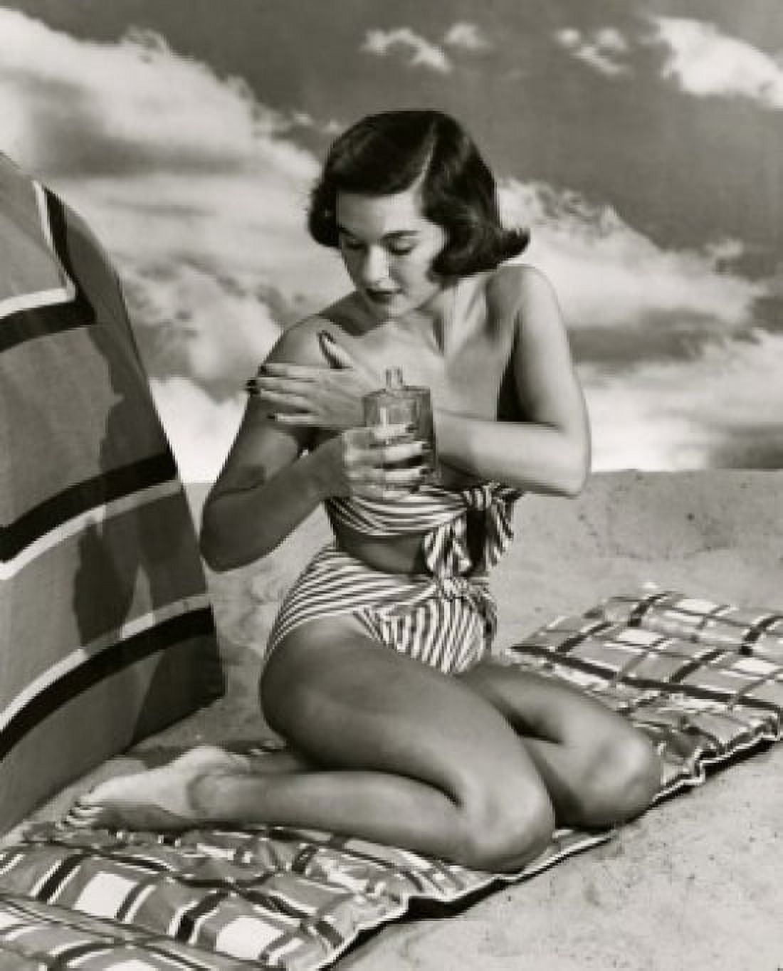 Young woman applying suntan lotion Canvas Art - (18 x 24)