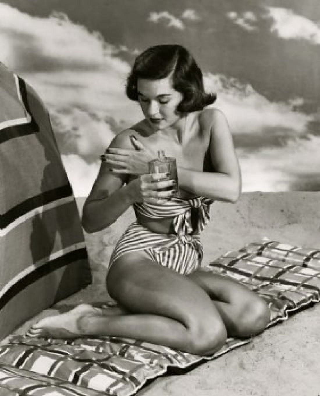 Young woman applying suntan lotion Canvas Art - (24 x 36)