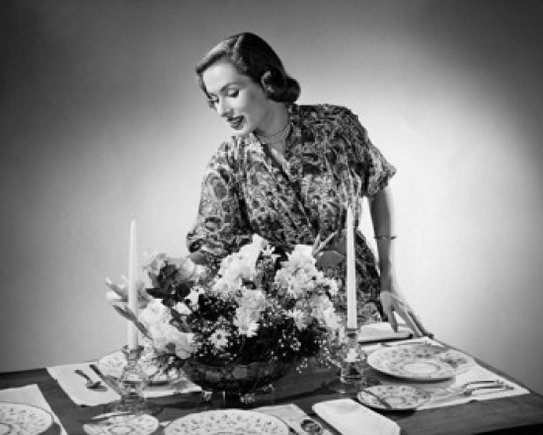 Young woman arranging flowers at a dining table Canvas Art - (18 x 24)