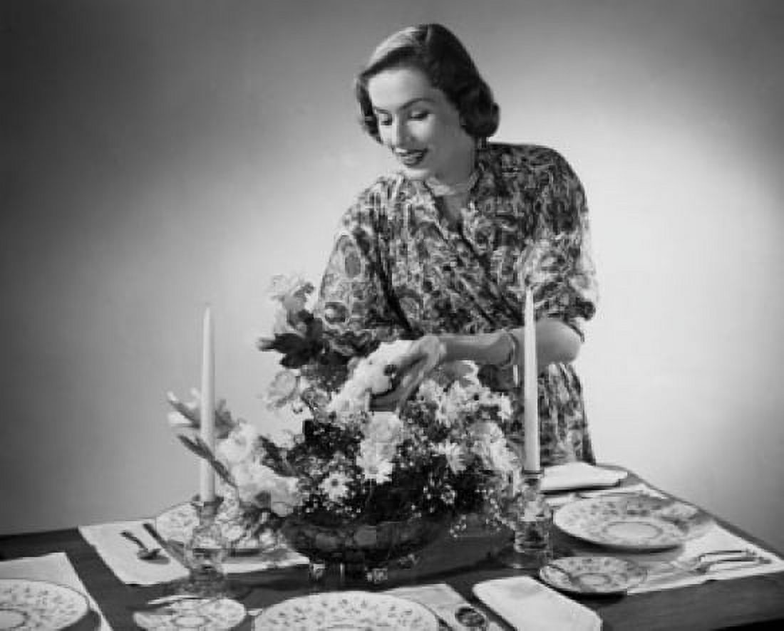 Young woman arranging flowers at a dining table Canvas Art -  (24 x 36)