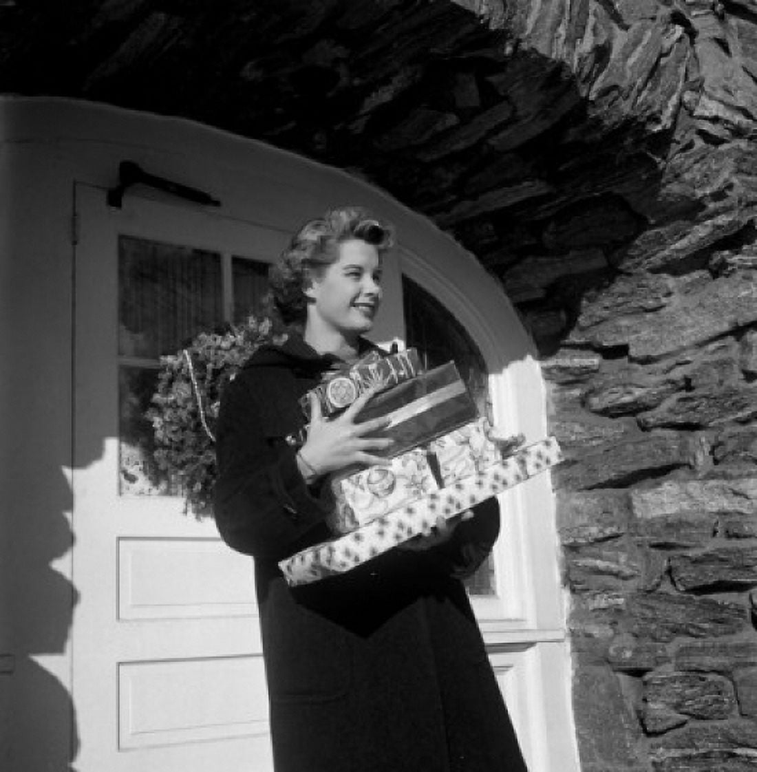 Young woman carrying Christmas gifts Canvas Art - (24 x 36)