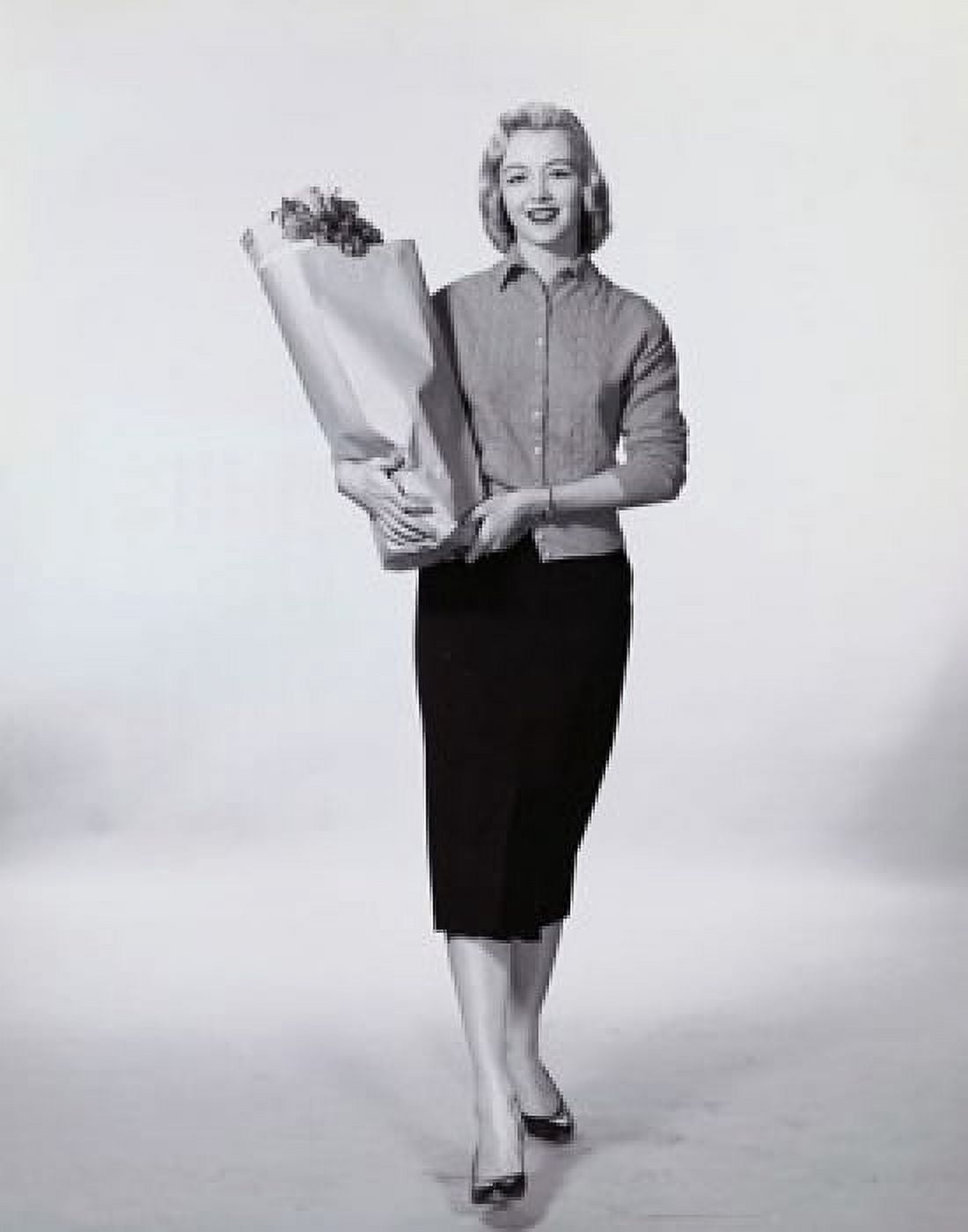 Young woman carrying a paper bag Canvas Art - (18 x 24)