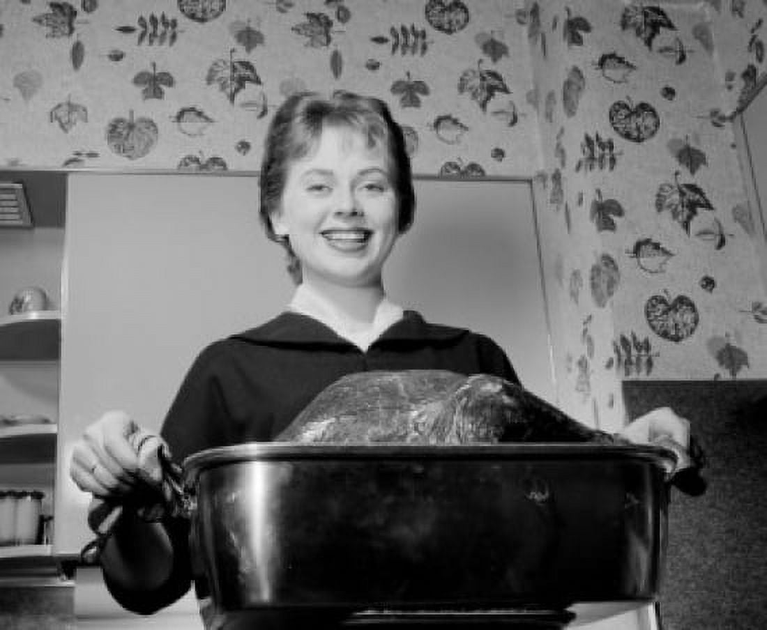 Young woman carrying roast turkey Canvas Art - (24 x 36)